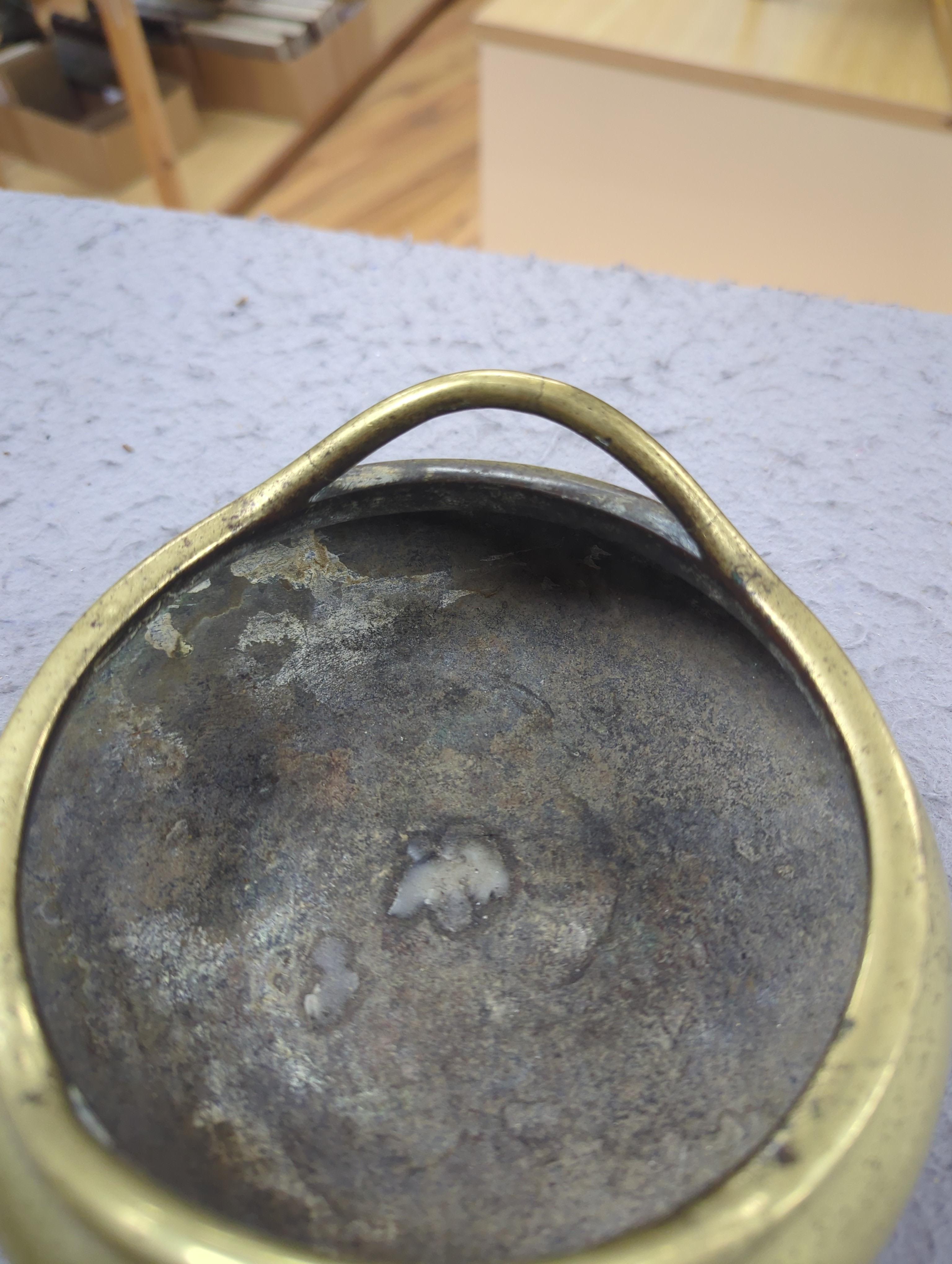 A late 19th century Chinese bronze censer with twin handles, apocryphal Xuande mark, 17.5cm in diameter